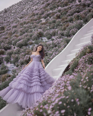 Crafted with layers of soft tulle, the dress exudes elegance and charm