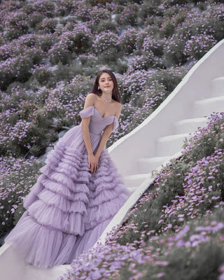 This ethereal lavender gown features an off-the-shoulder sweetheart neckline with ruched detailing