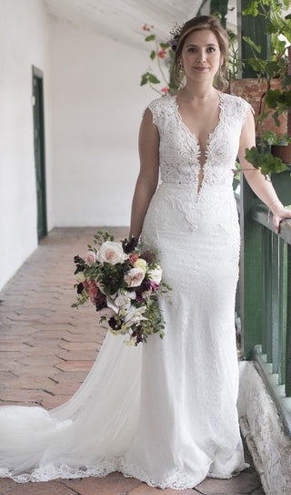 A stunning lace wedding gown featuring a deep V-neckline, intricate floral embroidery, and cap sleeves, ideal for a bride seeking an elegant and timeless look.