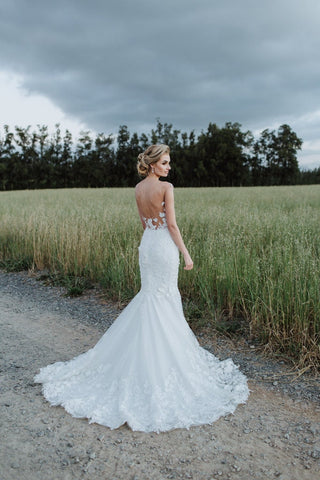 Elegant ivory bridal gown featuring intricate 3D floral lace embroidery, strapless sweetheart neckline, illusion short sleeves, and a mermaid fit-and-flare design, ideal for romantic and glamorous weddings