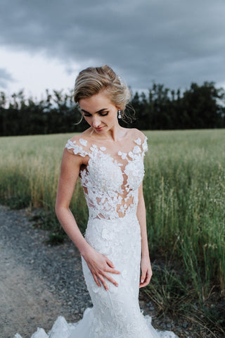 Chic ivory strapless wedding dress with floral lace detailing, sweetheart neckline, illusion off-the-shoulder short sleeves, and mermaid silhouette, perfect for a stylish and contemporary bridal style