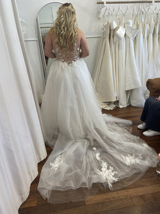 Elegant ivory tulle wedding dress, featuring 3D floral embroidery, off-the-shoulder puff sleeves, deep V-neckline, and high slit, ideal for modern brides seeking a princess-inspired gown