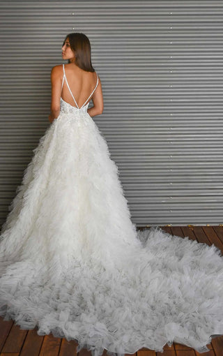 Timeless lace wedding dress with a princess-inspired silhouette and dramatic ruffled train for a fairytale bridal look