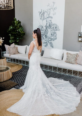 A sweeping train enhances the gown’s elegance, perfect for creating a grand entrance