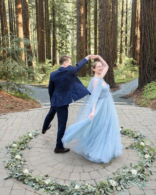 Dreamy light blue sparkling tulle gown with sheer cape sleeves, perfect for woodland weddings or fairy-tale-inspired celebrations,