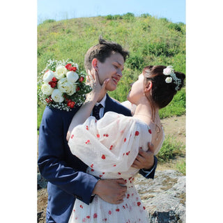 Romantic ivory tulle gown adorned with bold red cherry embroidery, a deep V-neckline, and airy puff sleeves, perfect for nature-inspired celebrations and whimsical summer weddings