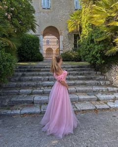 Romantic pastel pink dress with delicate floral appliqués, a full flowing skirt, and off-the-shoulder design, ideal for prom, weddings, or whimsical evening wear