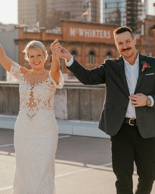 Elegant ivory wedding dress featuring detailed floral embroidery, sweetheart neckline, off-the-shoulder sleeves, and a dramatic tulle A-line design, ideal for romantic and timeless bridal styles