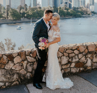 Chic ivory tulle ball gown with floral lace applique, off-the-shoulder sweetheart neckline, and a floor-length A-line silhouette, tailored for sophisticated and magical wedding celebrations