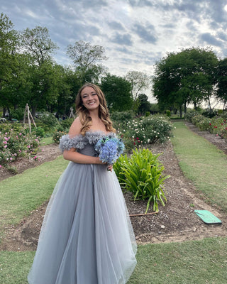 Chic ivory wedding dress with floral lace detailing, off-the-shoulder sweetheart neckline, and a dramatic A-line silhouette, tailored for glamorous and sophisticated bridal looks