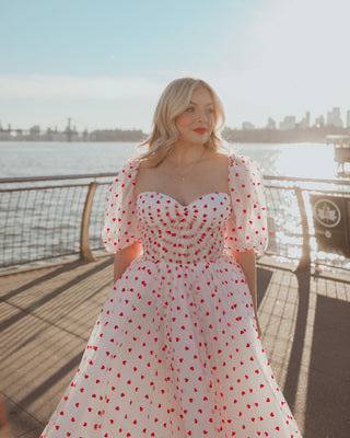 Elegant ivory wedding dress featuring a heart pattern, puff sleeves, A-line tea-length silhouette, and a timeless design, ideal for romantic and vintage bridal looks