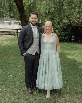 Elegant green lace dress with a sweetheart neckline and soft bow-tied straps, combining timeless charm with modern detailing for an enchanting look