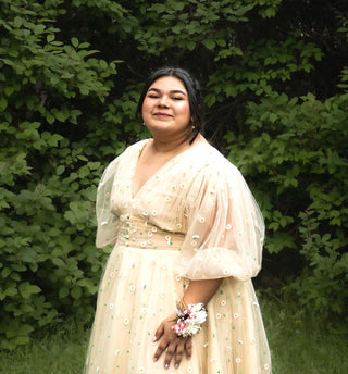 Elegant cream yellow gown adorned with intricate daisy floral embroidery, A-line midi tea-length design with a deep V-neckline and puff sleeves, ideal for whimsical weddings and fairycore-inspired occasions