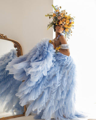 Dreamy pastel blue dress with layers of frothy tulle ruffles and a structured bodice, ideal for weddings or ethereal-themed events.