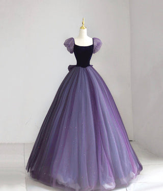 This gown boasts a dramatic ballgown silhouette with a rich, gradient tulle skirt transitioning from deep violet to soft lavender