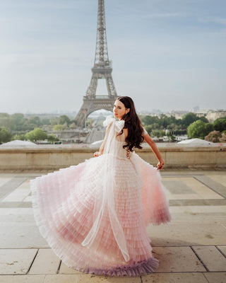 Elegant ivory wedding dress featuring layered frill detailing, off-the-shoulder sweetheart neckline, and a flowing tulle ball gown design, ideal for romantic and timeless bridal looks