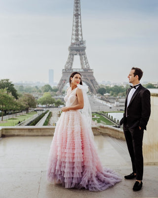 Ivory off-the-shoulder ball gown with layered frill tulle design, sweetheart neckline, and a floor-length A-line silhouette, perfect for elegant weddings and fairy-tale bridal styles