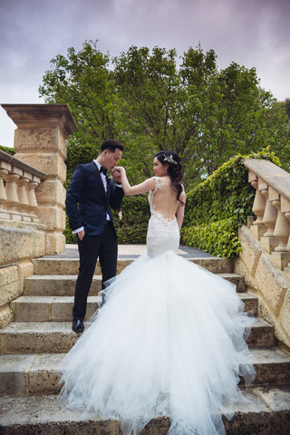 Sophisticated bridal dress with intricate lace detailing, mermaid silhouette, floor-length train, timeless white design, ideal for classic church ceremonies or luxurious receptions