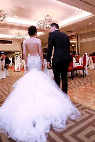 Stunning lace wedding gown, tailored fit with feminine floral accents, sweetheart neckline with sheer straps, flowing tulle train, perfect for elegant and traditional weddings