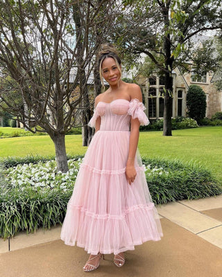 Custom bridal gown with a ruffled layered tulle skirt, strapless sweetheart neckline, and a dramatic A-line silhouette, perfect for elegant and romantic weddings