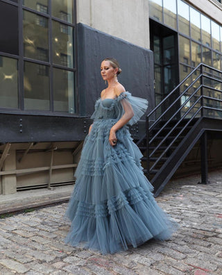 Stunning steel-blue tulle gown with layered ruffles and off-shoulder detailing, perfect for modern formal events