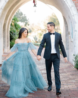 Elegant blue evening dress featuring cascading ruffled tiers and a structured bodice, ideal for galas and luxury parties