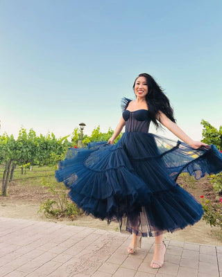 A captivating navy blue gown with a strapless, corset-style bodice for a structured yet delicate silhouette