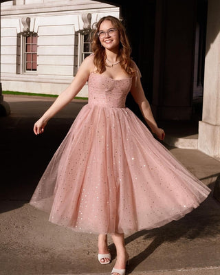 Blush pink tulle dress with sparkling sequins, fitted bodice with a sweetheart neckline, and a flowing tea-length skirt, perfect for proms, garden parties, or romantic occasions