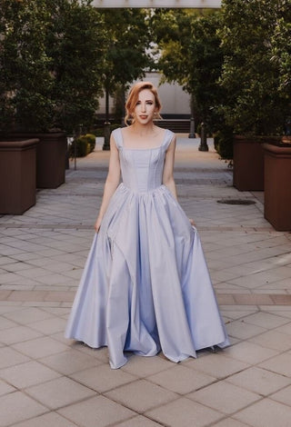 Elegant lavender ball gown with a structured square neckline, fitted corset bodice, and a voluminous floor-length skirt, perfect for romantic evening events and fairy-tale weddings