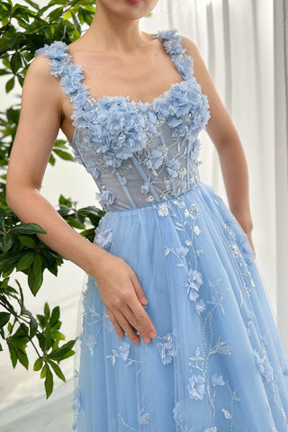 Ethereal light blue gown featuring intricate 3D floral appliqués, a corset-style bodice with delicate silver embroidery, and a flowing tulle skirt, perfect for whimsical weddings or fairy-tale-inspired events