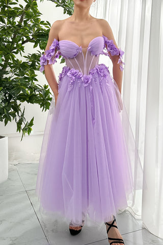 This captivating lilac gown exudes modern femininity with its vibrant floral accents and flattering silhouette. The tulle fabric gives the dress a light, ethereal feel, while the corset-inspired waist enhances its structured shape. The thoughtful placement of flowers on the neckline and straps adds a unique and elegant touch, making this dress a perfect balance of sophistication and grace.