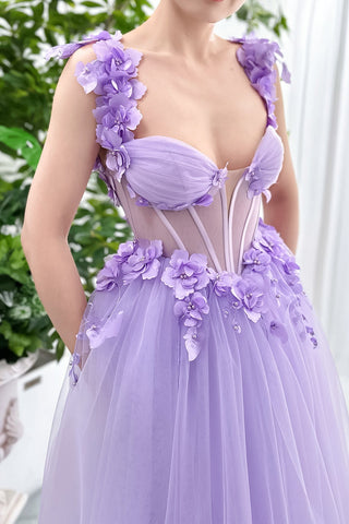 Designed with a whimsical touch, the dress combines a light purple shade with intricate floral appliqué for a fresh, youthful vibe. The fitted bodice accentuates the waist, while the flowy tulle skirt offers comfort and movement. With its delicate detailing and airy feel, this dress is a standout choice for bridesmaids or anyone celebrating a special occasion in style. Its romantic design effortlessly elevates any gathering.