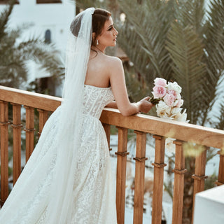 Beautiful lace wedding gown with a sweetheart neckline and delicate floral patterns, perfect for a bride seeking an elegant yet simple style.