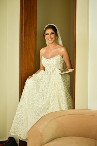 Classic strapless lace wedding dress with intricate floral embroidery, designed for a timeless and romantic bridal look.