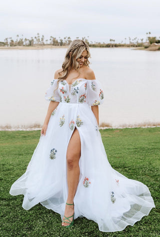 Whimsical off-shoulder floral embroidered dress, perfect for a casual or boho-themed wedding or event.