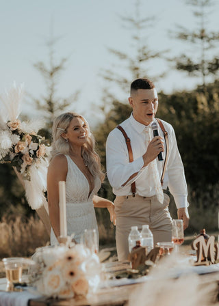 Modern bridal look featuring a figure-hugging wedding dress with leafy lace detailing and sheer accents