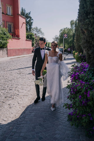 Modern bridal style featuring a sparkly A-line dress with sheer details, complemented by a sleek hairstyle and veil