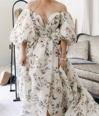 Romantic off-the-shoulder floral dress, puff sleeves with vintage-inspired design, pastel flower pattern on white fabric, high slit detail, elegant gown for weddings, garden parties, or spring events