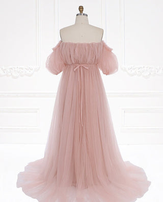 Timeless off-shoulder tulle dress in a delicate blush hue, offering soft textures and graceful movement for a romantic look.