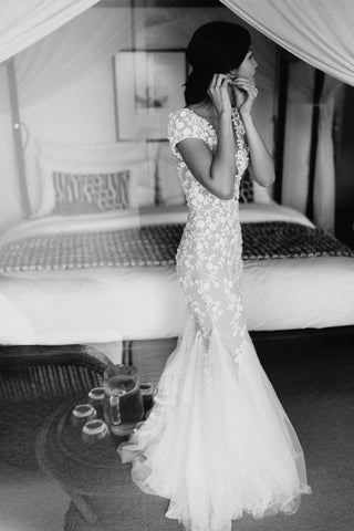 Chic ivory tulle ball gown with floral lace applique, off-the-shoulder neckline, sweetheart bodice, and a dramatic A-line silhouette, tailored for timeless and glamorous bridal styles