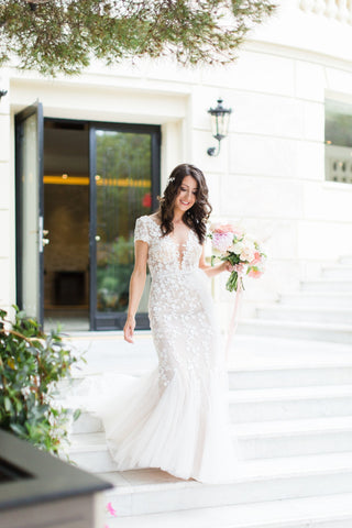 Sophisticated ivory A-line ball gown with floral embroidery, off-the-shoulder sweetheart neckline, and a tulle silhouette, designed for elegant and enchanting wedding celebrations