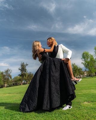 Sophisticated black satin gown, crinkle design with lace detailing, off-the-shoulder neckline, A-line ball gown silhouette perfect for proms, gothic-themed parties, and formal gatherings