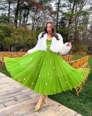 Chic green floral midi dress with embroidered daisies, lightweight tulle fabric, and tiered skirt, complemented by a fitted bodice, perfect for whimsical gatherings or daytime occasions