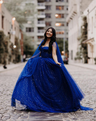 Chic dark blue celestial dress, shimmering gold starry accents, sweetheart neckline with long cape sleeves, perfect for formal occasions, glamorous events, and starry-night themed celebrations