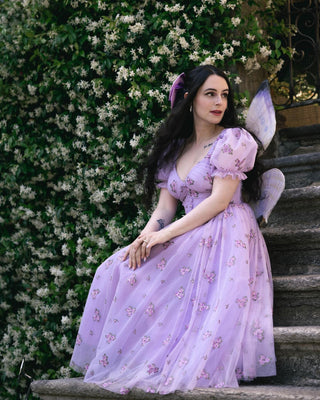 A romantic lilac tulle dress with puffed sleeves and delicate floral embroidery, perfect for fairy-tale-inspired events