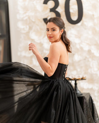 Elegant black tulle gown with pleated detailing, strapless A-line silhouette, tea-length design, ideal for gothic-inspired proms, fairycore-themed weddings, or special formal events