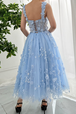 Romantic pastel blue dress adorned with layered floral details, sheer bodice with silver vine accents, and a full tulle skirt, ideal for garden parties, proms, or fantasy-themed celebrations