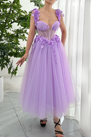 This enchanting lilac dress features a soft tulle skirt adorned with delicate floral embellishments, creating a dreamy and romantic aesthetic. The structured bodice with a sweetheart neckline is enhanced by strategically placed flower details on the straps and waist, making it an ideal choice for those seeking a chic and feminine look. Perfect for weddings, formal occasions, or evening parties, this dress captures both elegance and playful charm.